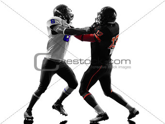 two american football players on scrimmage holding silhouette
