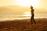 teenage girl  balance slackline silhouette on the beach
