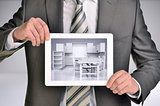 Man holding internet tablet. Kitchen in tablet screen. Gray background