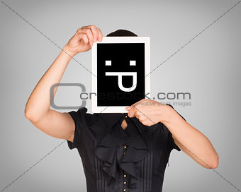 Girl in dress covered her face with tablet. On screen code smiley