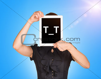 Young girl in dress covered her face with tablet. On screen code smiley