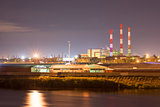 Industrial area with power plant and river port. Behind the houses, in front of water