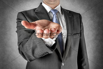 Businessman holds out hand