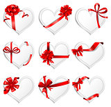 Festive heart-shaped  cards with red gift ribbons.