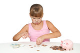 Thoughtful  girl with piggy bank isolated