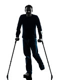 injured man with crutches silhouette