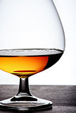 Part of  glass with cognac on white background
