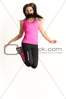 Young fitness woman jumping high