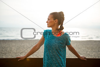 Portrait of fitness young woman on beach in the evening