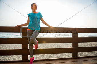 Portrait of fitness young woman on beach in the evening