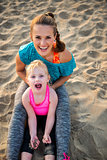 Portrait of healthy mother and baby girl on beach