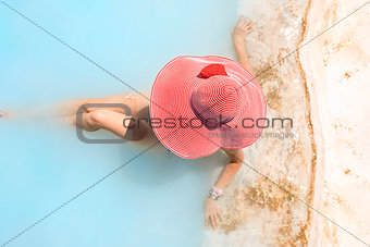 woman in a red hat takes a relax bath