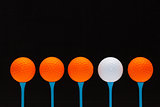 Golf balls on blue wooden tees