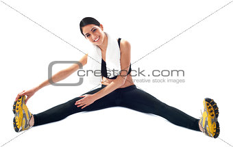 Young fit female trainer doing stretching