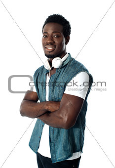 Man standing with headphones around his neck