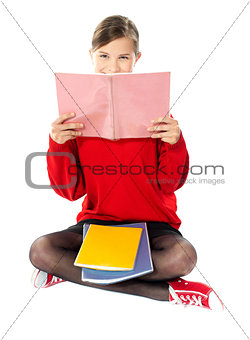 Girl sitting with books on her lap