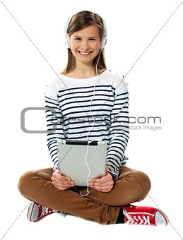 Teenager enjoying music through headphones