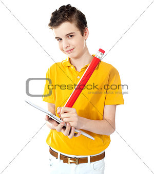 Cute boy writing on his notebook
