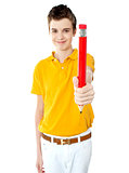 Portrait of a boy offering pencil