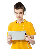 Boy listening to music on tablet pc