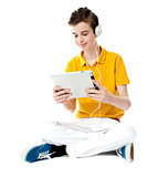 Seated boy watching video on tablet