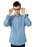 Young boy holding eyeglasses