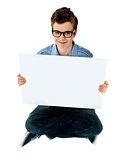 Smiling boy presenting blank whiteboard
