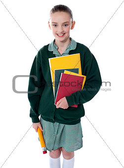 School girl standing with notebooks