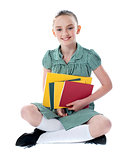 Beautiful girl holding school books