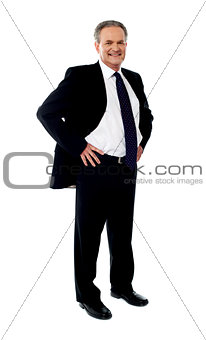 Senior businessman posing with hands on his waist