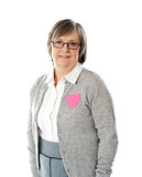 Woman with pink paper heart on her jacket