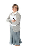Senior woman holding spiral notepad and pen