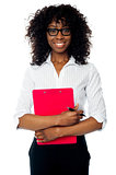 Corporate woman posing with clipboard and pen