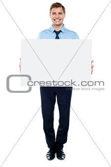 Businessman holding blank white billboard
