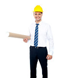 Successful male builder holding blueprints