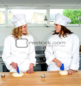 Two female chefs looking at each other