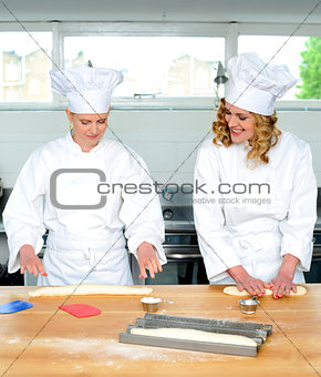 Senior chef teaching newbie female chef