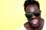 Closeup of joyful young african guy in sunglasses