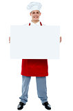 Chef holding blank advertising board