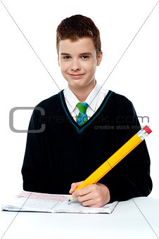 School boy writing on notebook