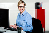 Smiling help desk woman typing on keyboard