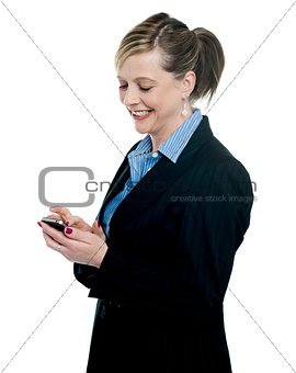 Businesswoman reading message on her mobile
