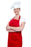 Confident female chef posing with crossed arms