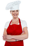 Smiling female cook with crossed arms