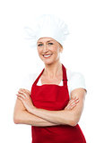 Middle aged female chef posing with crossed arms
