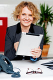 Cheerful businesswoman using portable tablet
