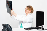 Smiling female surgeon looking at patients x-ray
