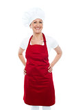 Female cook posing with hands on her waist