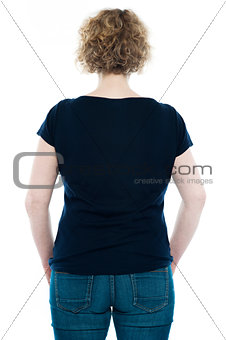 Rear view of curly haired stylish caucasian woman