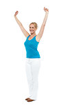 Successful woman posing with raised arms
